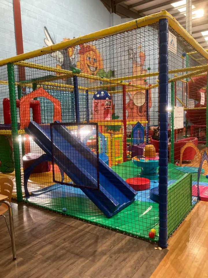 The netted toddler frame with its own small blue slide and soft shapes
